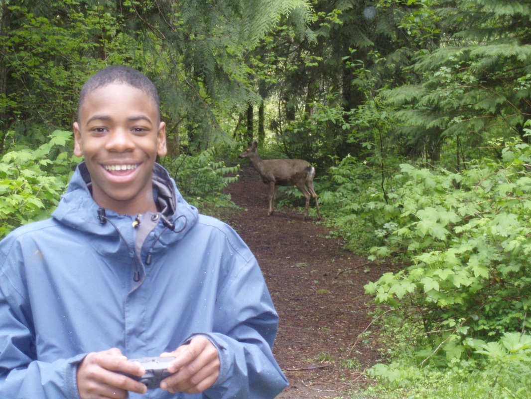 student with deer in background
