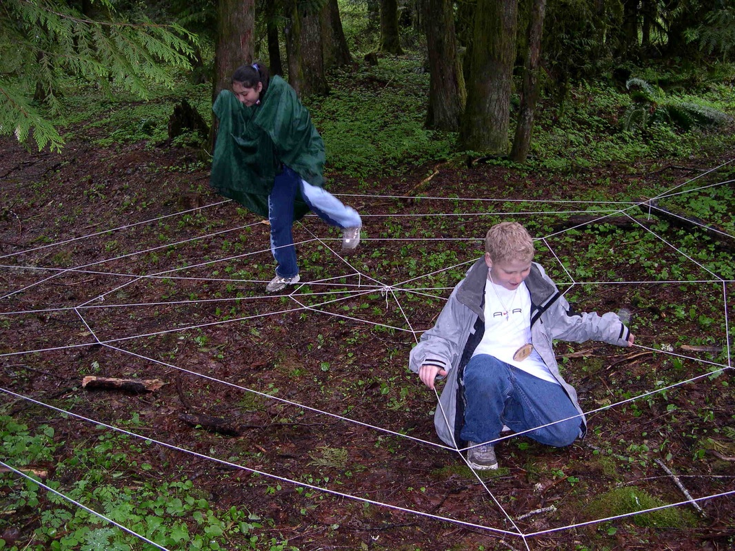 student doing spider web activity