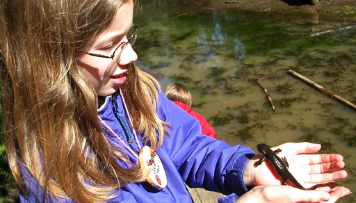 Student holding a newt