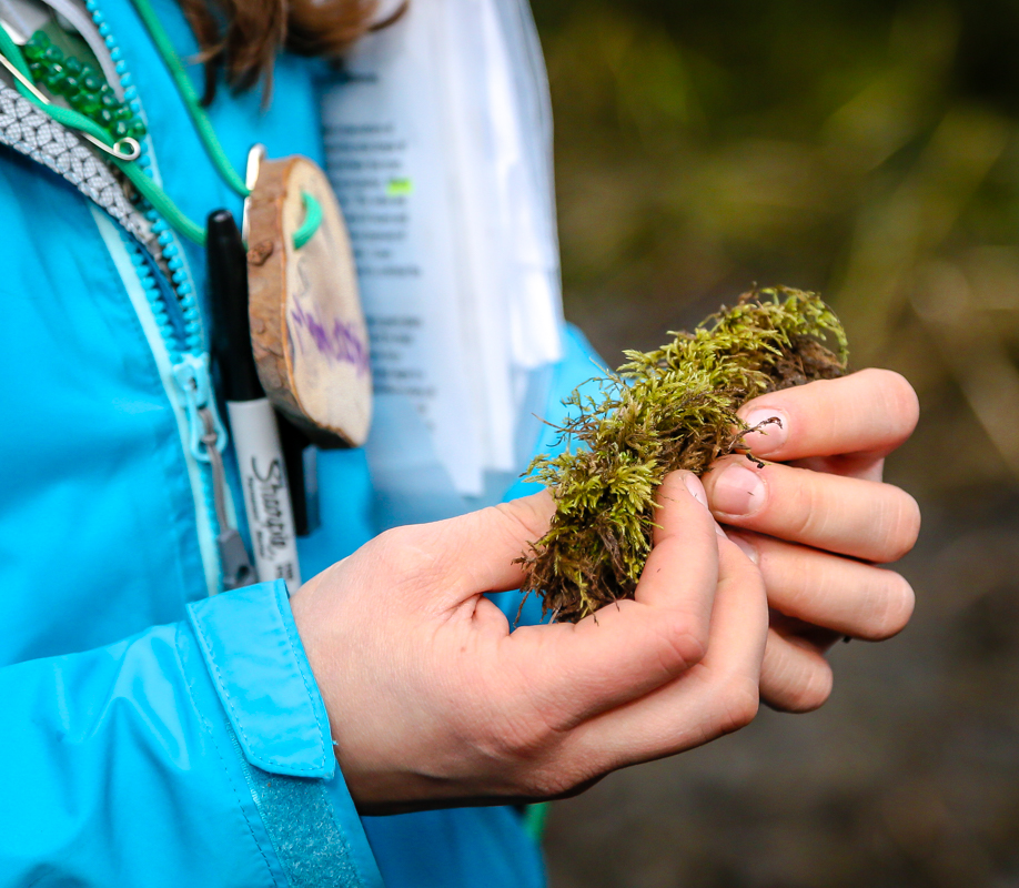 student holding moss